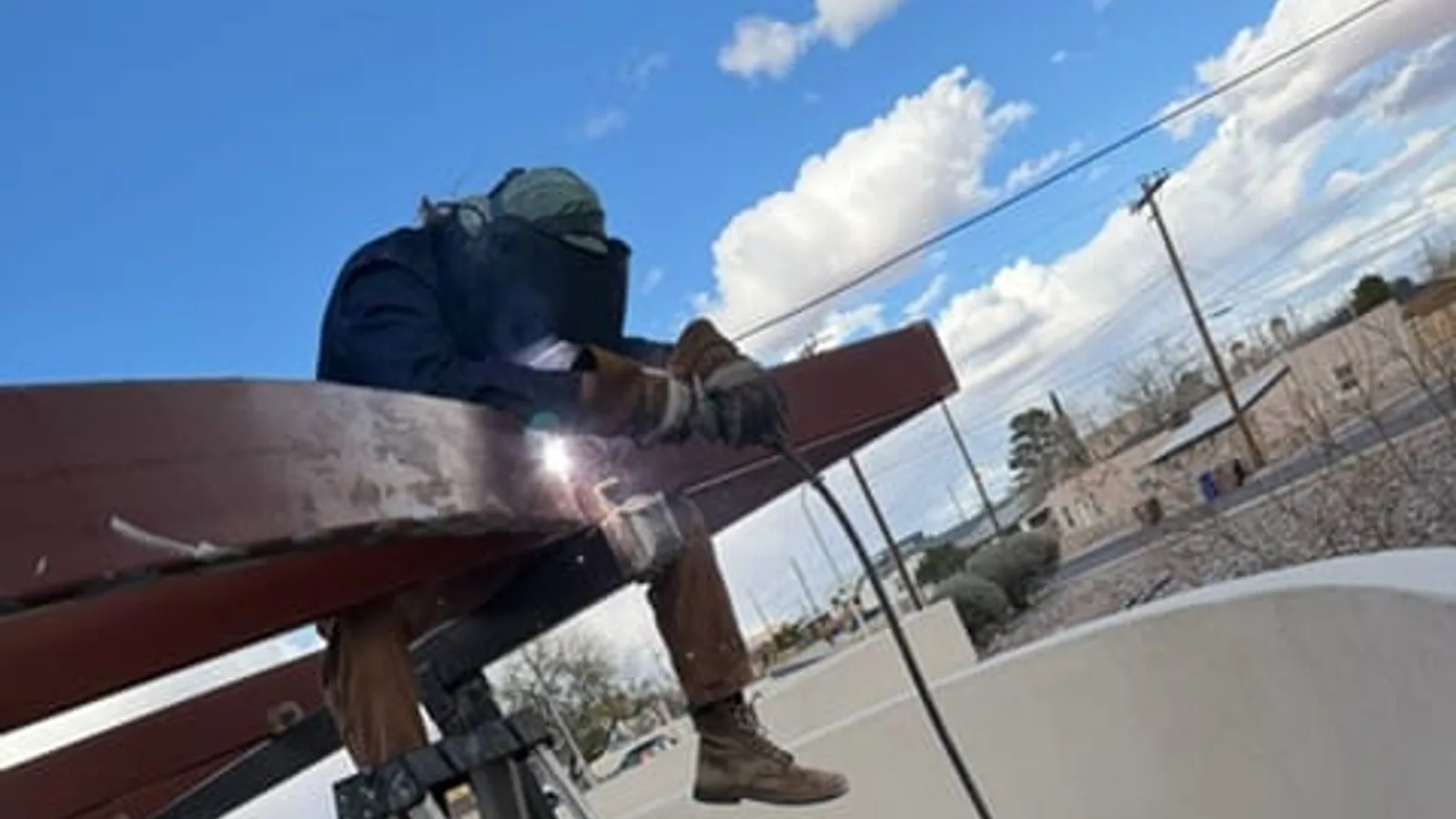 Welder making an on-site structural weld outdoors in Las Cruces