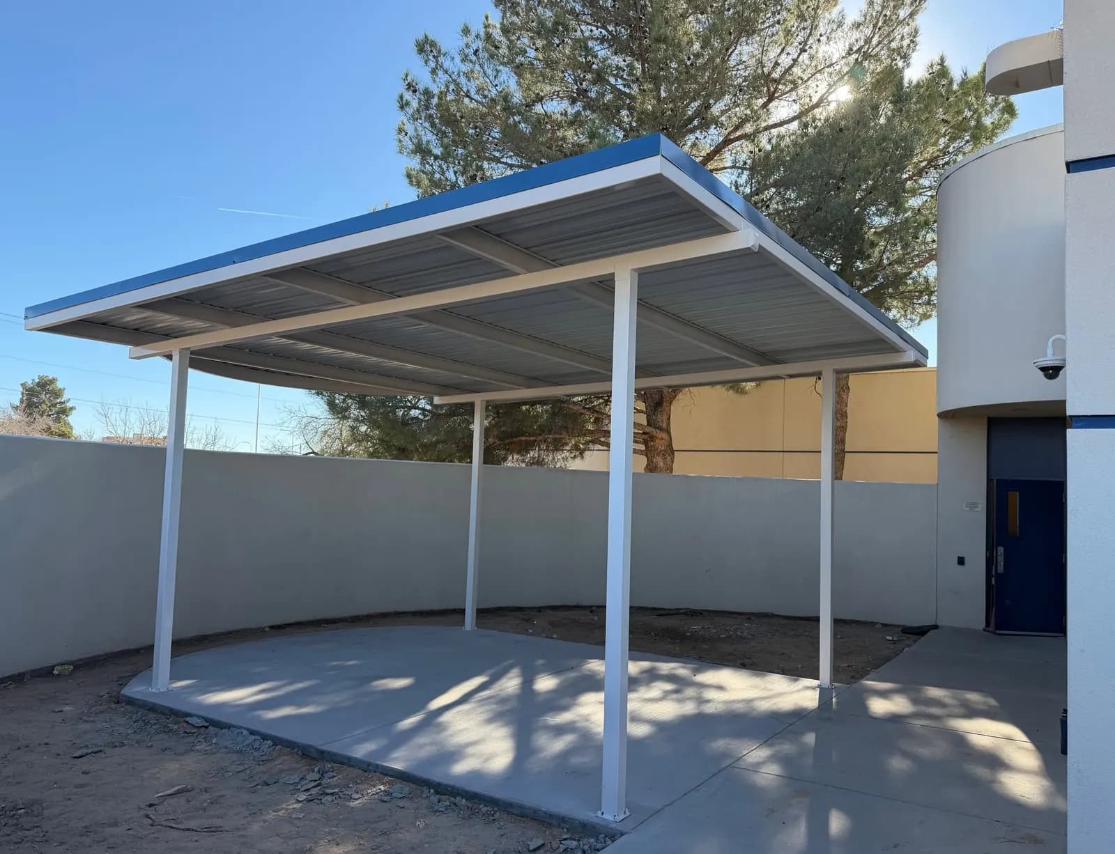 Freestanding commercial steel shade structure over a concrete pad, Las Cruces