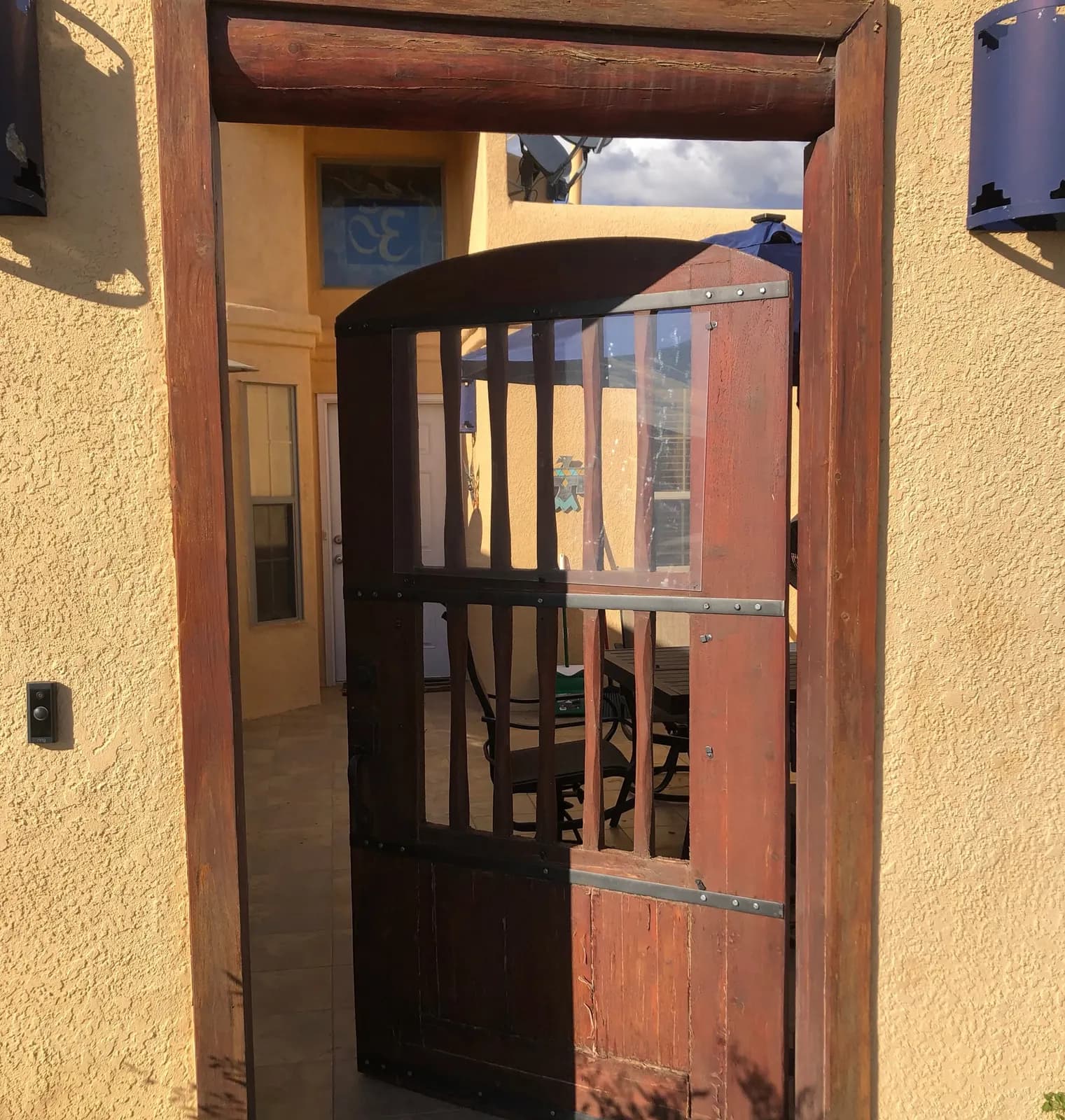 Old wooden courtyard gate before it was replaced with a custom steel gate