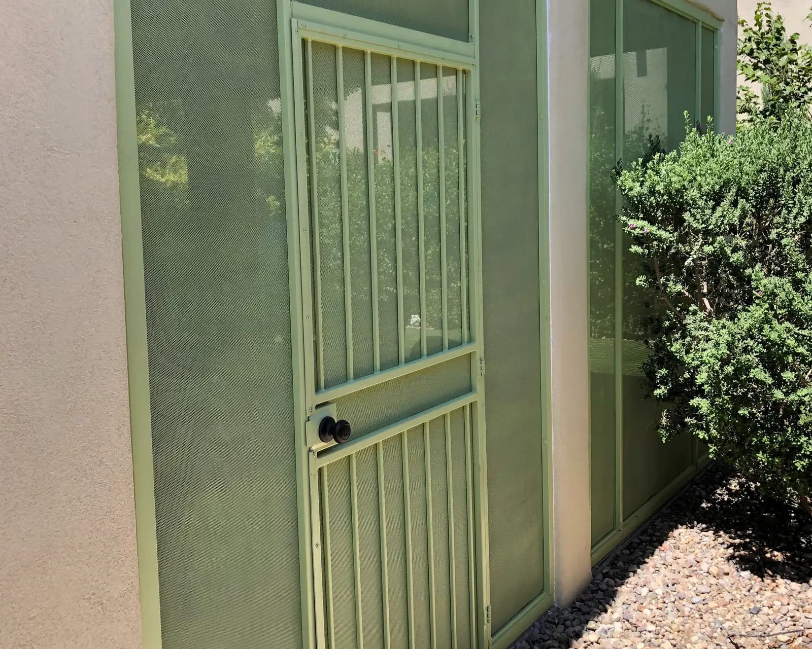 Screened patio enclosure with a matching steel screen door