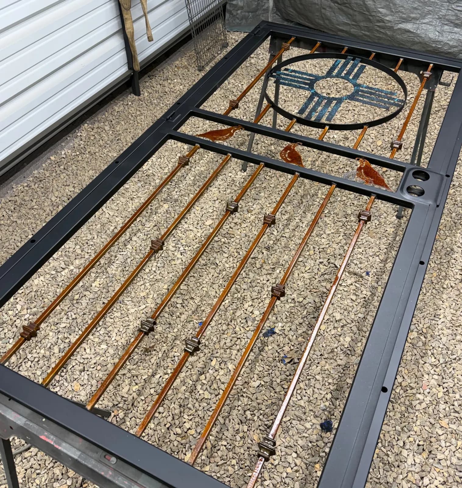 Security door frame with Zia sun and quail being fabricated on the shop floor