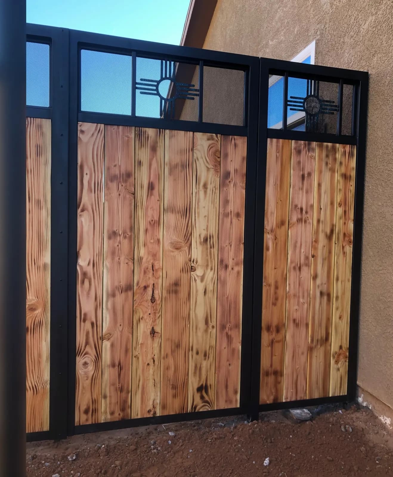 Wood-and-steel privacy screen panels with Zia sun transom windows