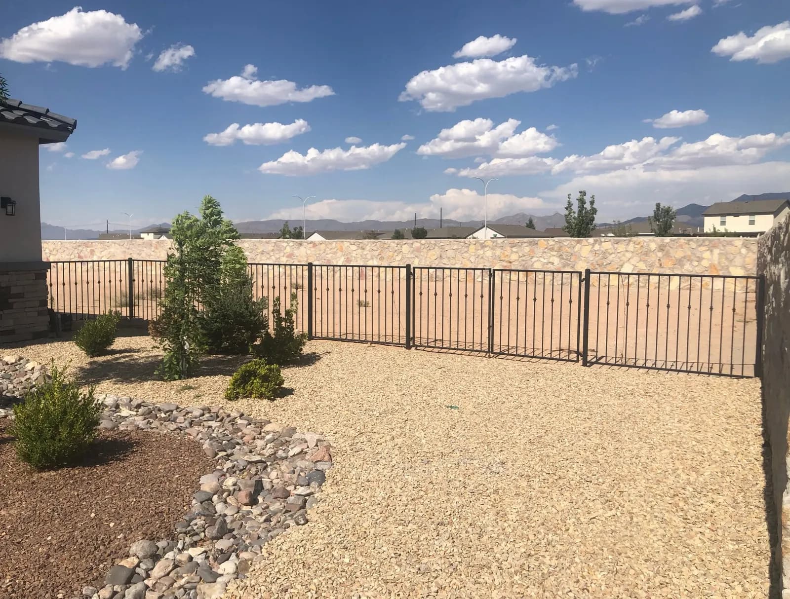 Wrought iron view fence facing open desert and distant mountains